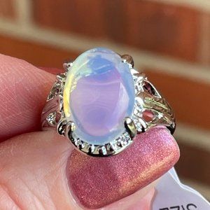 A milky white translucent stone set on a silvertone ring,  US size 7, NEW